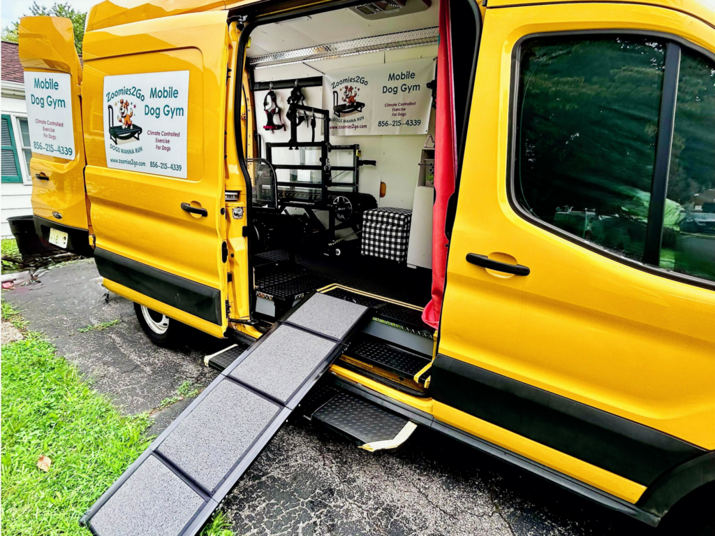 Zoomies2Go van with side door open and access ramp set up